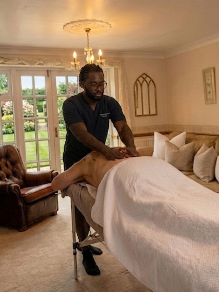 C.J providing a calm mobile massage treatment in a real home setting